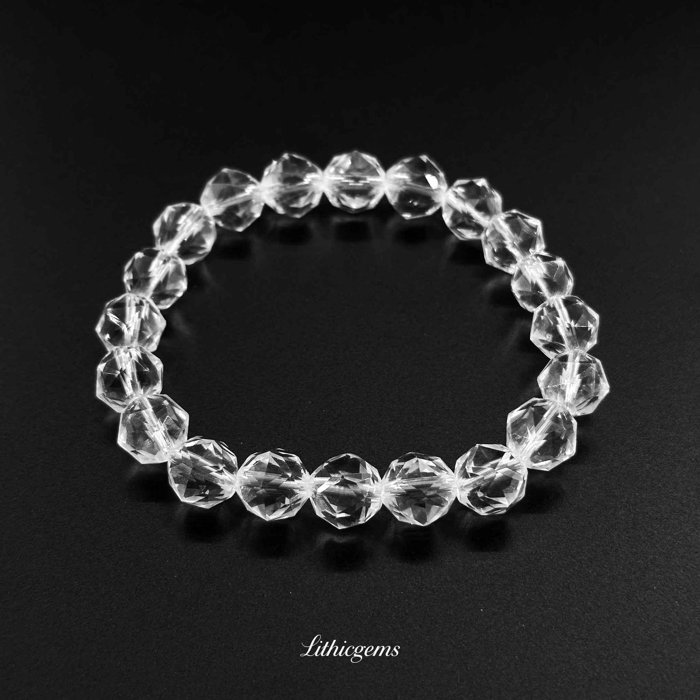 Clear crystal gemstone bracelet with faceted beads on black background, Lithicgems boutique