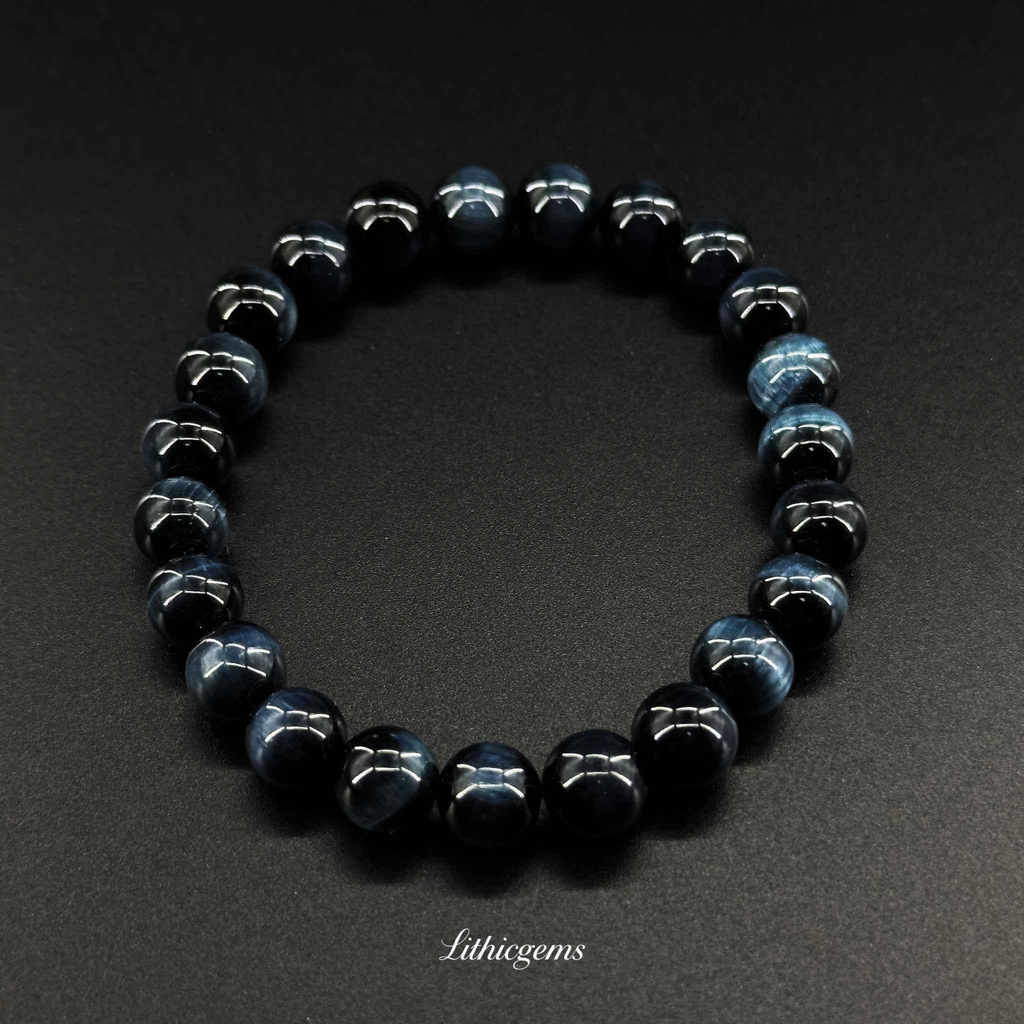 Blue tiger eye gemstone beaded bracelet on black background, Lithicgems crystal jewelry