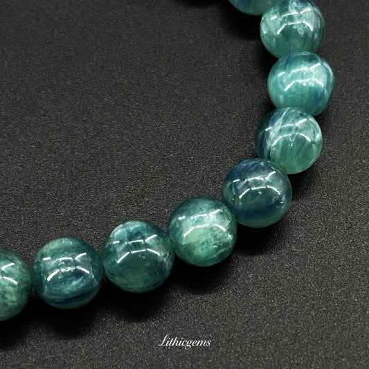 Blue-green crystal gemstone bead bracelet on black background, Lithicgems natural crystals