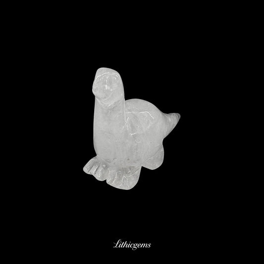 Clear quartz crystal dinosaur figurine on black background from Lithicgems boutique