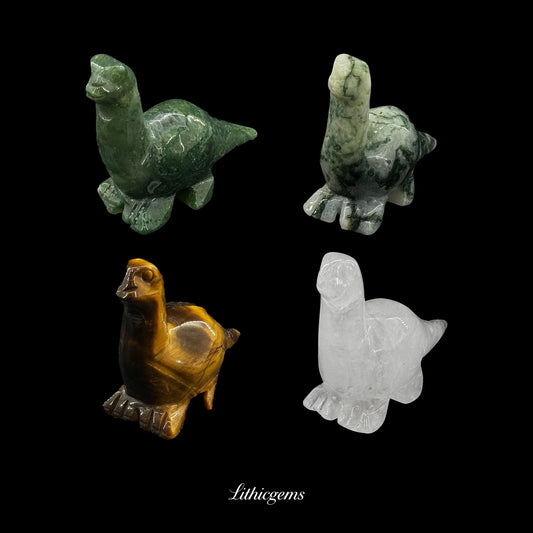 Four crystal dinosaur figurines in green, white, brown, and clear gemstones on black background