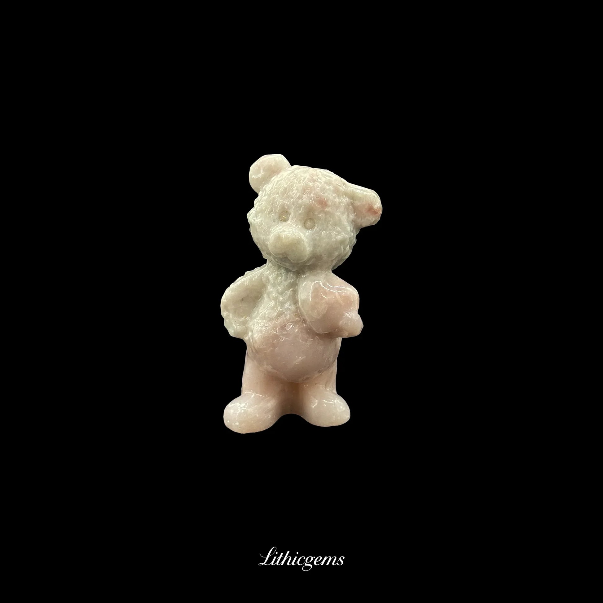 Rose quartz bear figurine on black background, premium healing crystal from Lithicgems