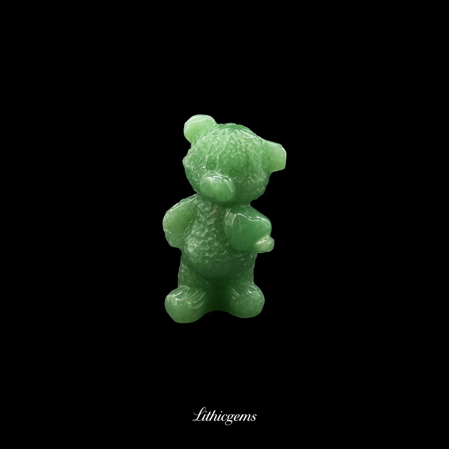 Green jade bear crystal figurine from Lithicgems, natural gemstone on black background