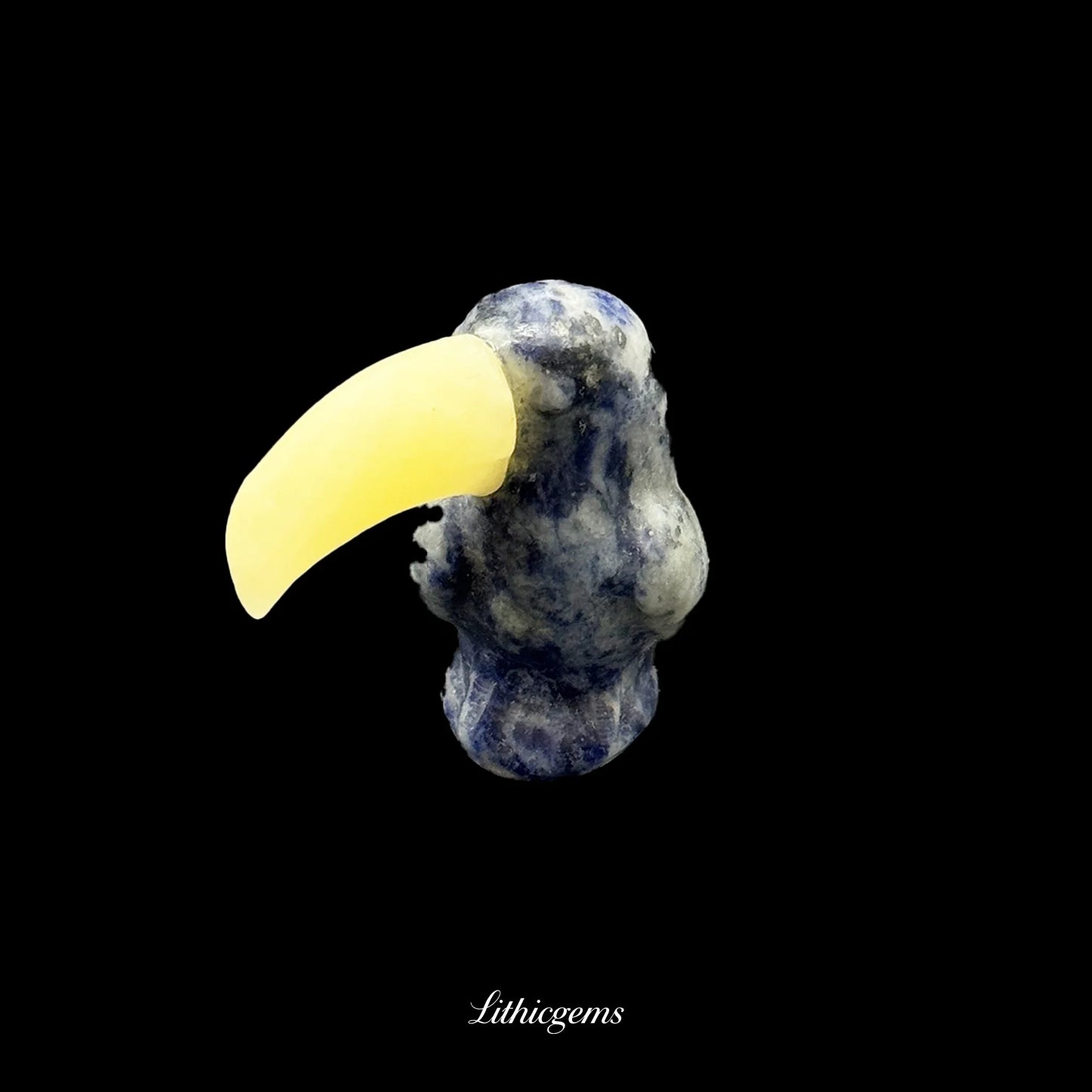 Blue and yellow gemstone toucan figurine on black background, Lithicgems natural crystals
