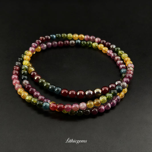 Multicolor polished gemstone beaded bracelet set on dark background with Lithicgems logo