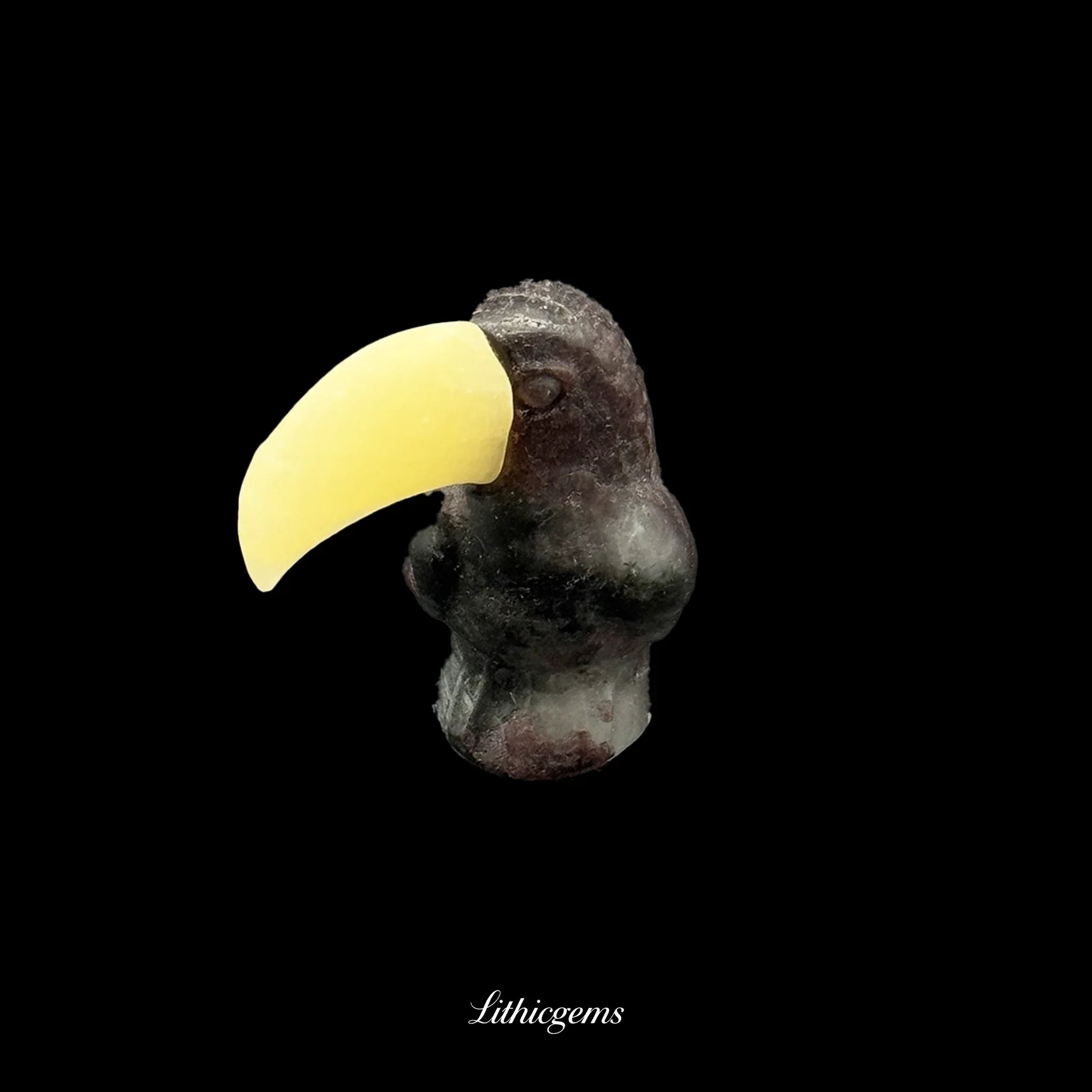 Crystal toucan figurine with yellow gemstone beak on black background, Lithicgems boutique