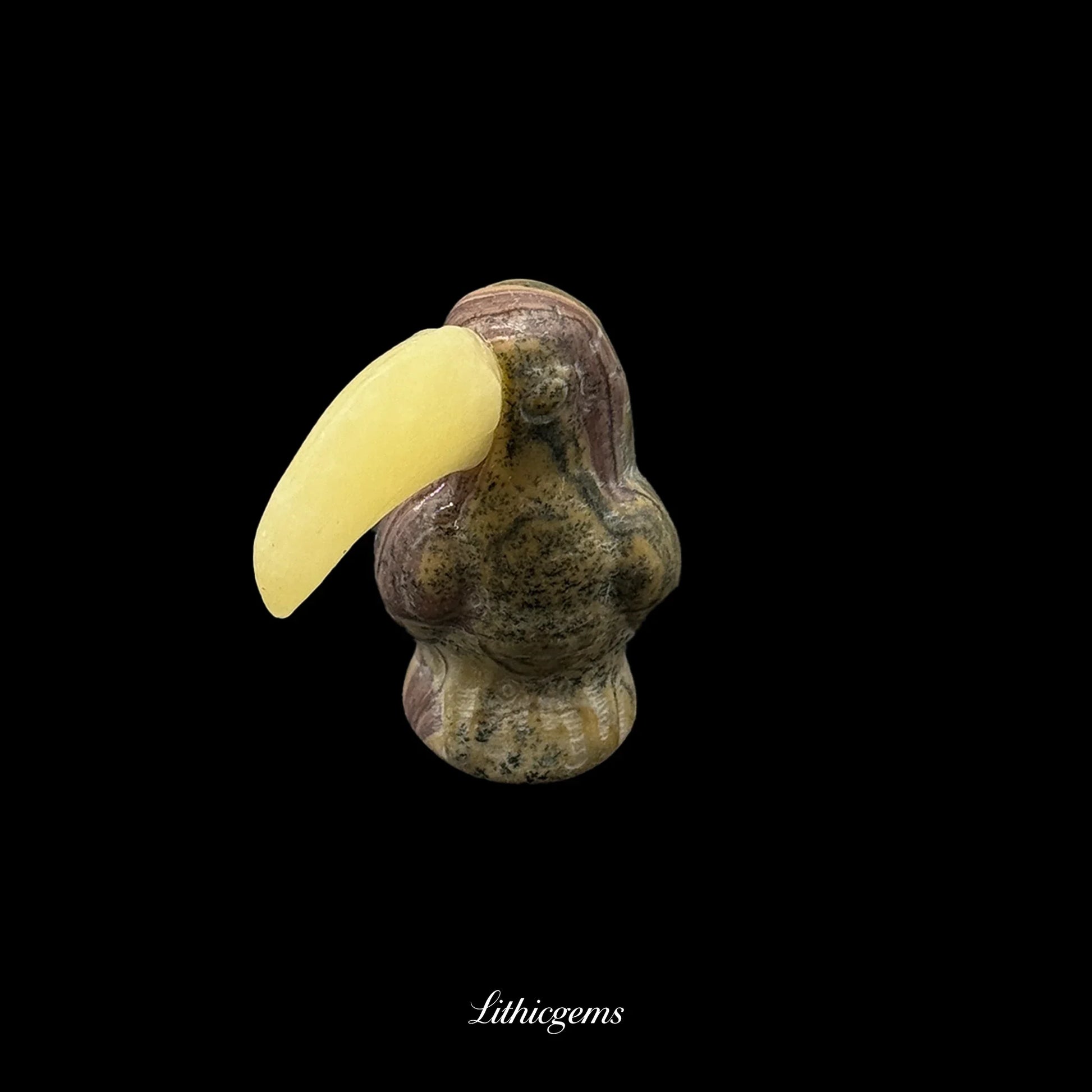 Natural gemstone toucan figurine with yellow beak on black background, Lithicgems boutique