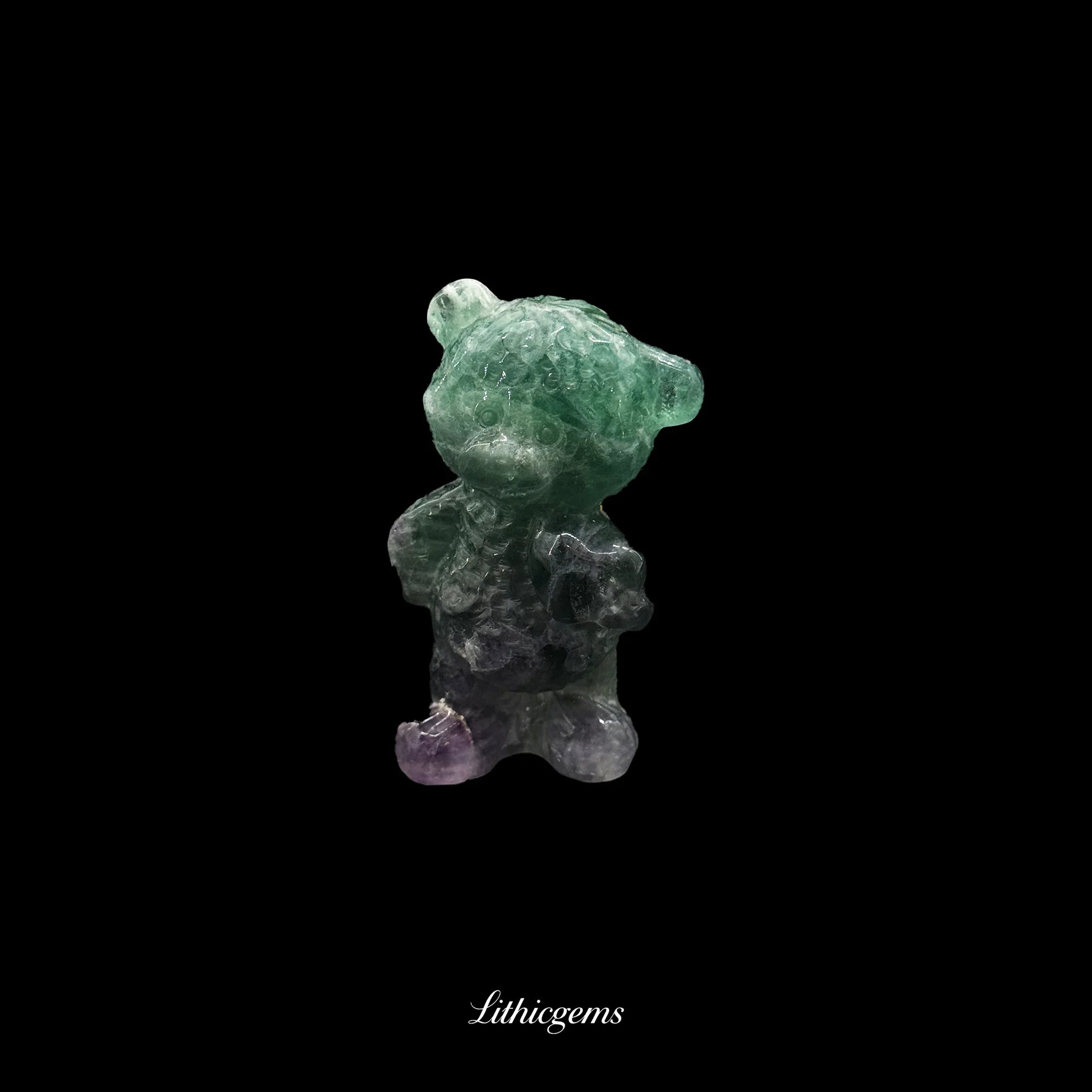 Fluorite bear crystal carving on black background, premium crystal from Lithicgems.