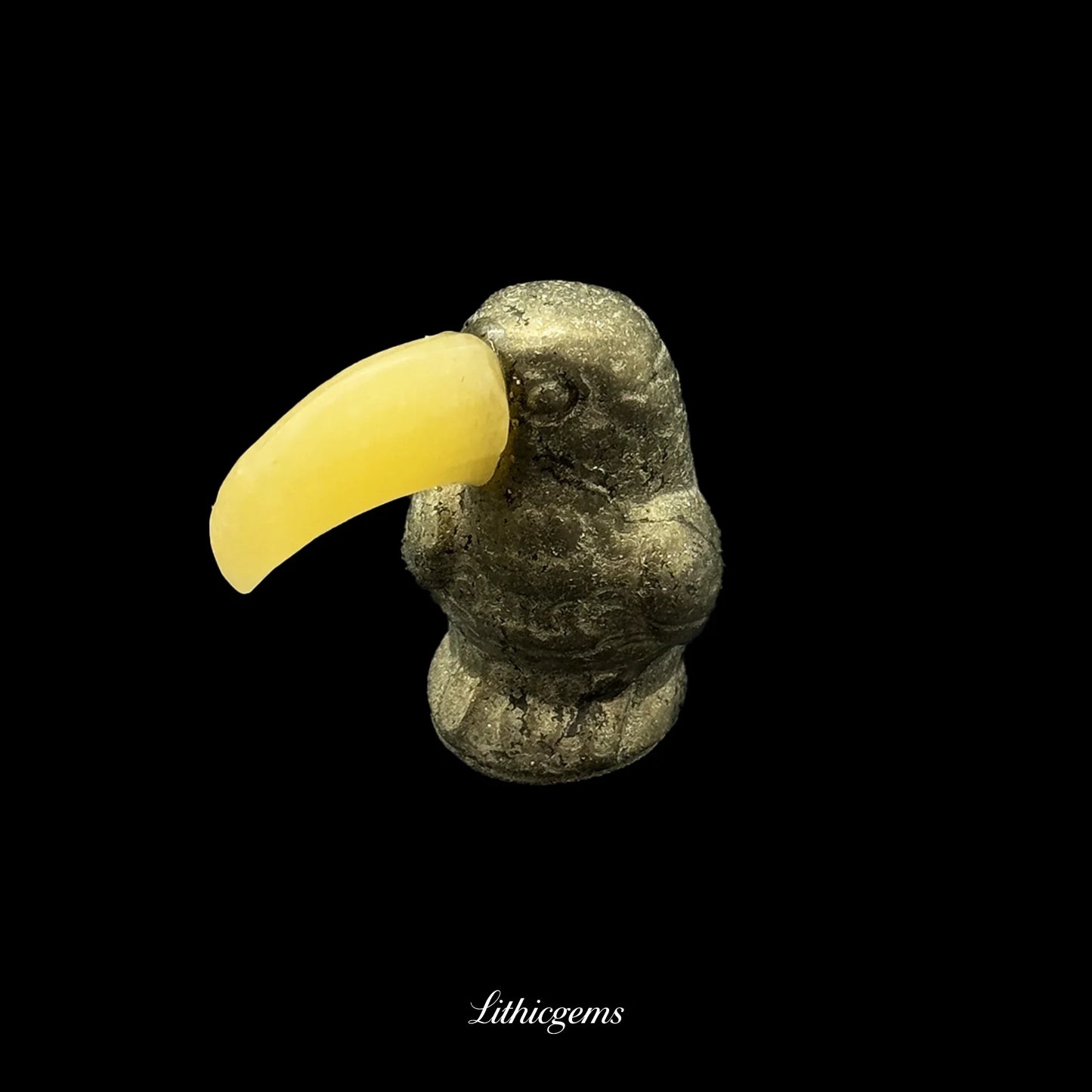 Natural crystal toucan figurine with yellow gemstone beak on black, Lithicgems boutique