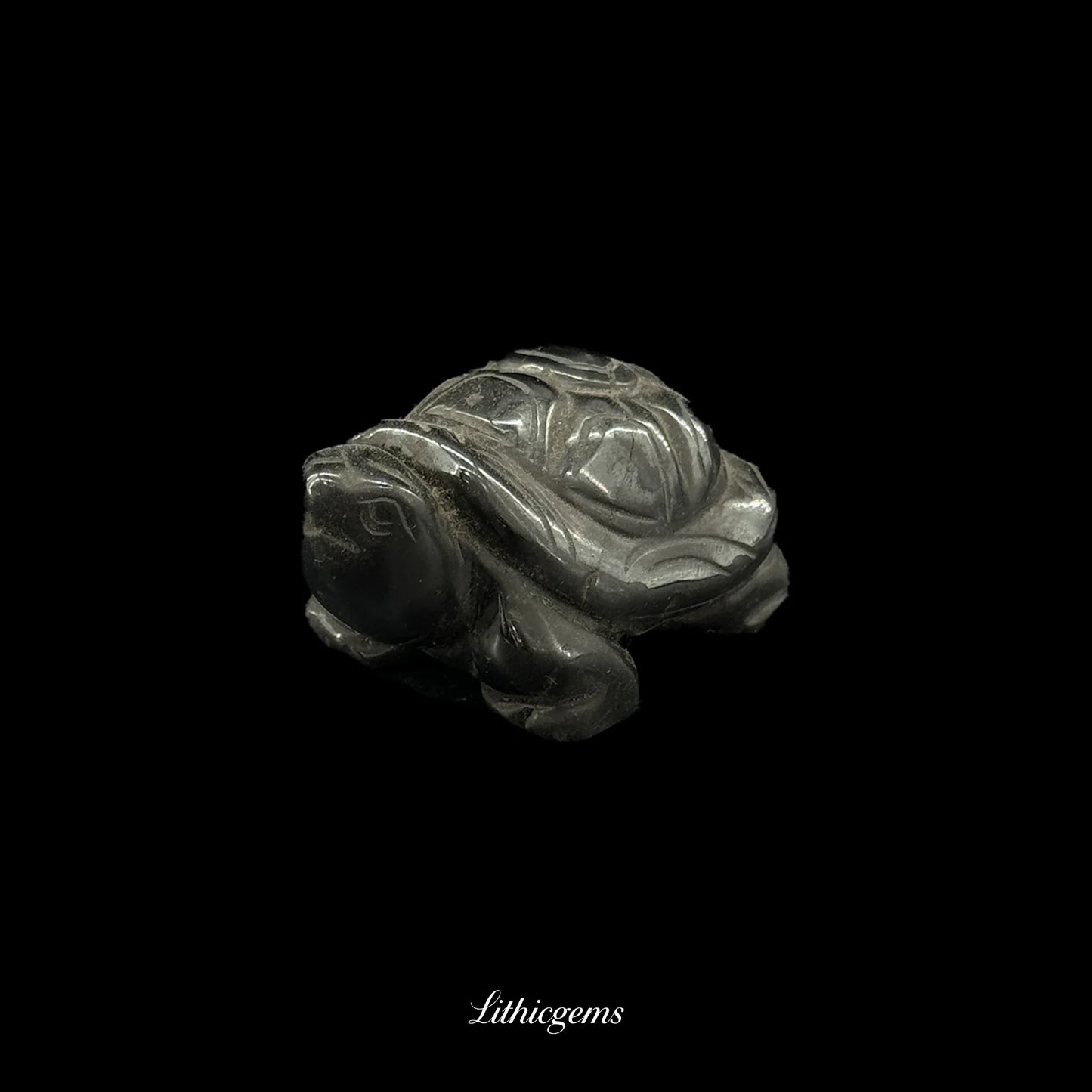 Hand-carved natural gemstone turtle figurine on black background from Lithicgems boutique