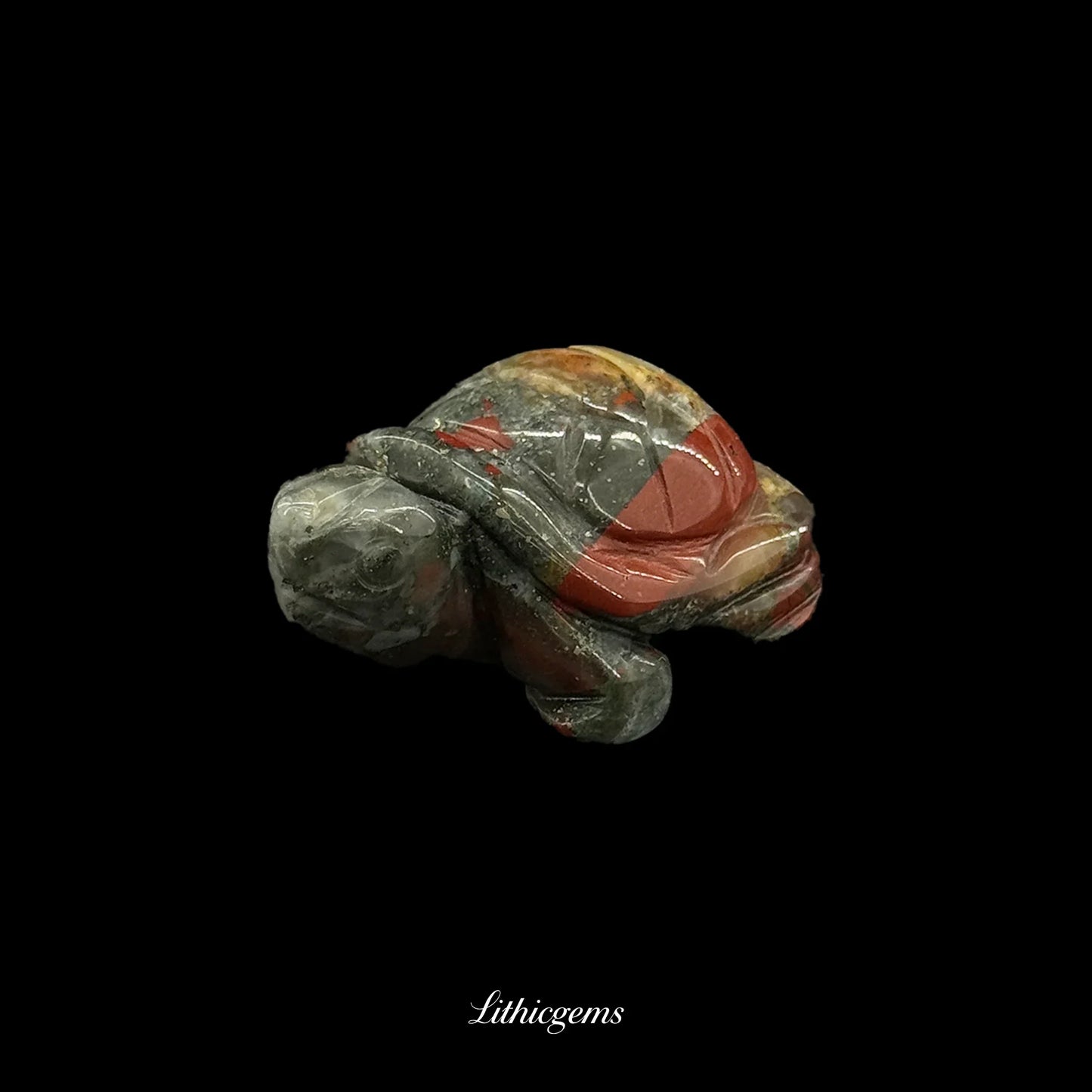Polished natural gemstone turtle figurine on black background, Lithicgems boutique