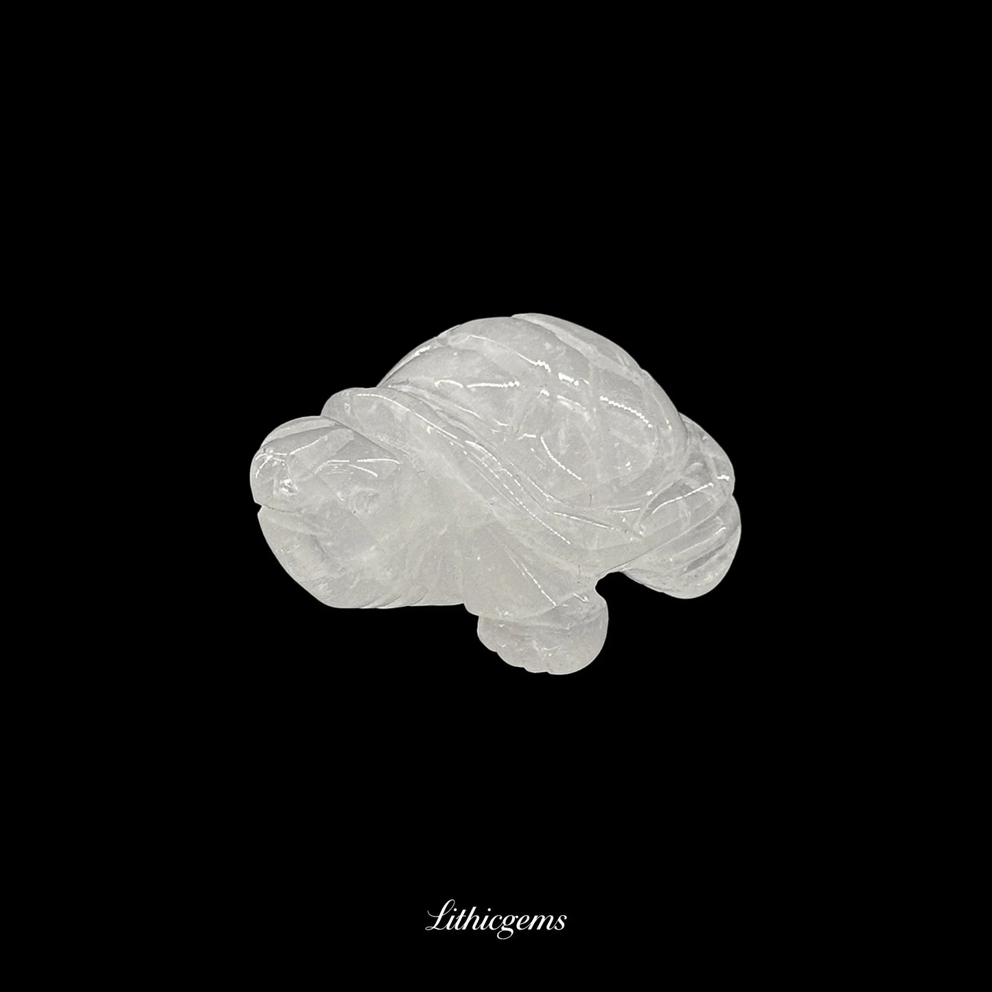 Clear quartz crystal turtle figurine on black background, Lithicgems premium gemstone