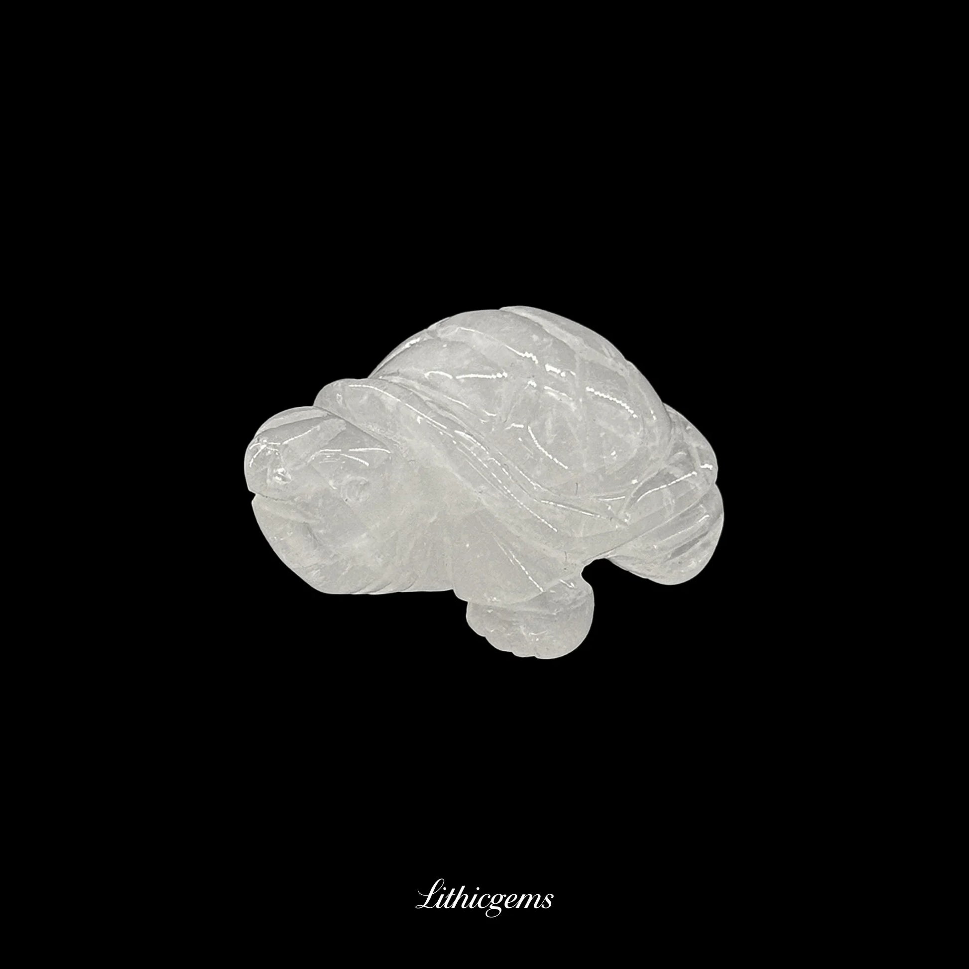 Clear quartz crystal turtle figurine on black background, Lithicgems premium gemstone