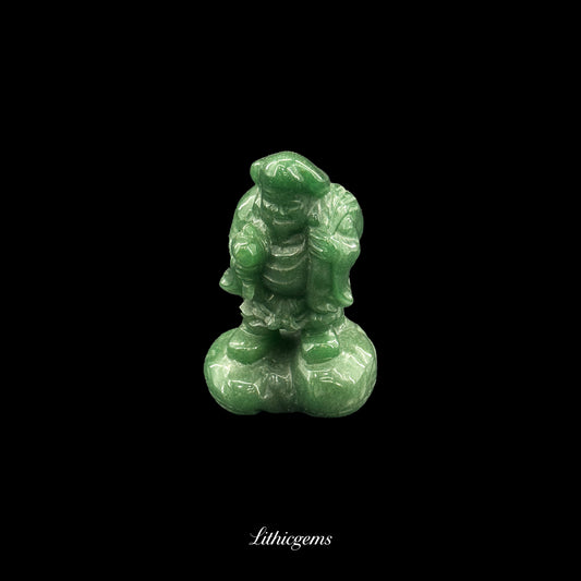 Green gemstone figurine of a standing character with detailed clothing on a black background, Lithicgems