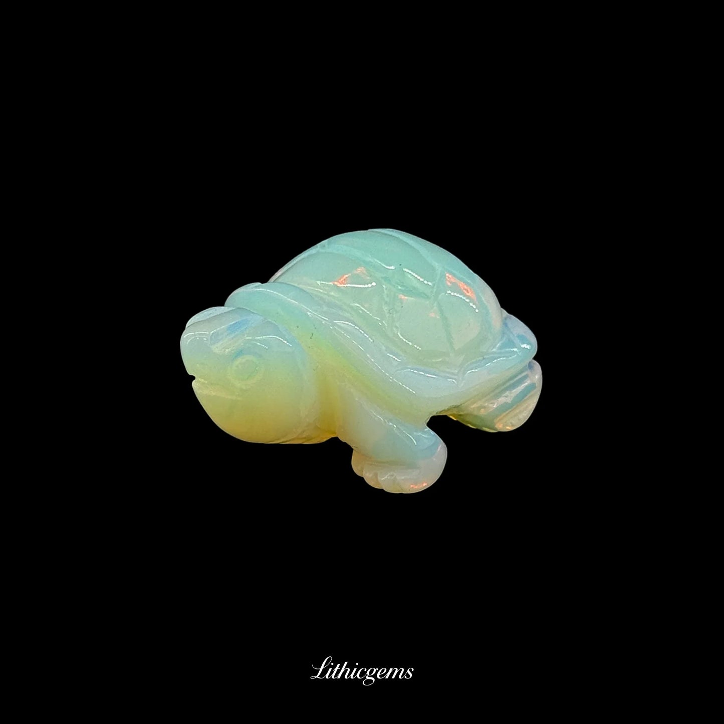 Opalite crystal turtle figurine on black background, Lithicgems gemstone boutique