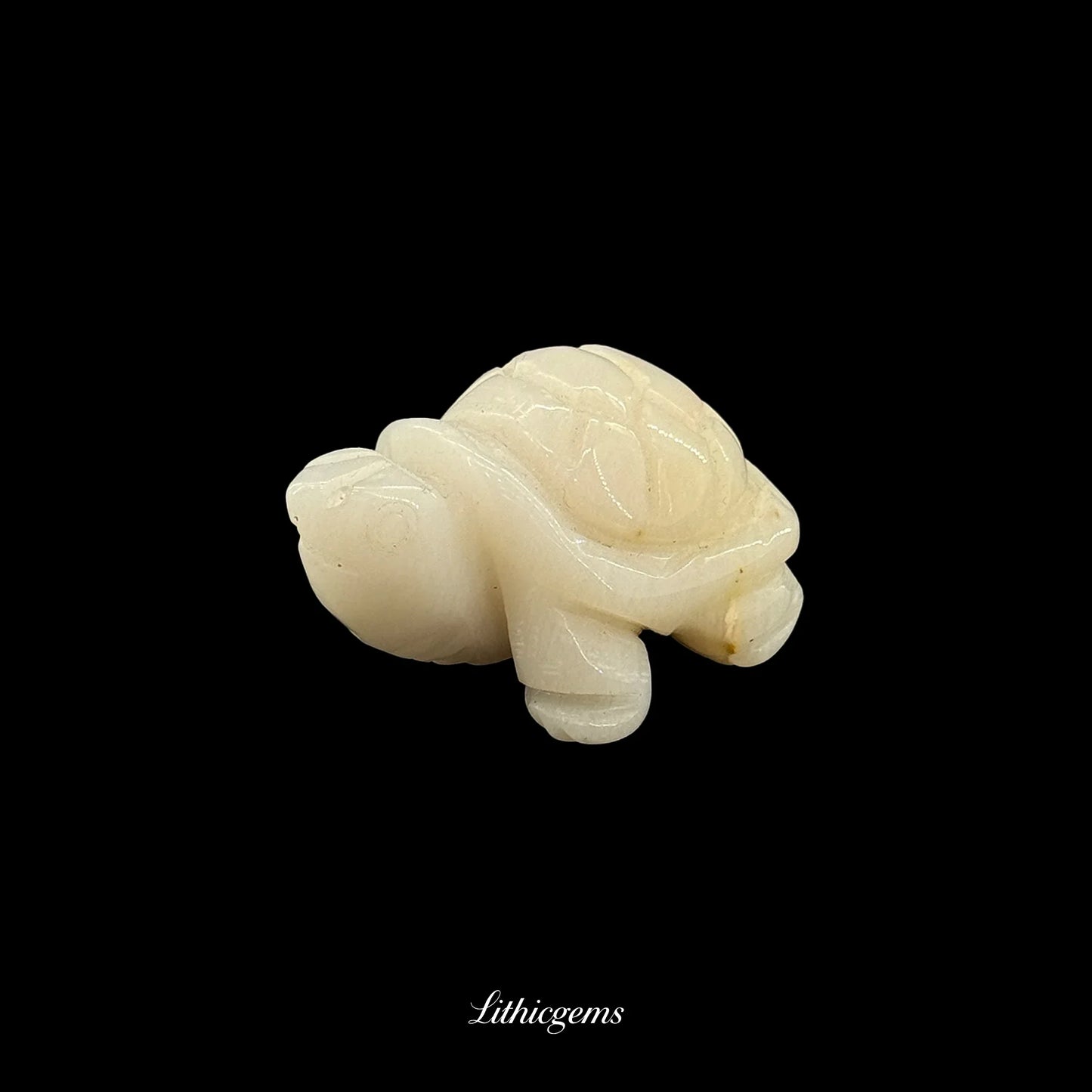 White crystal turtle figurine, natural gemstone carving on black background, Lithicgems