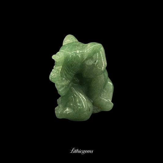 Green aventurine elephant crystal figurine from Lithicgems on black background