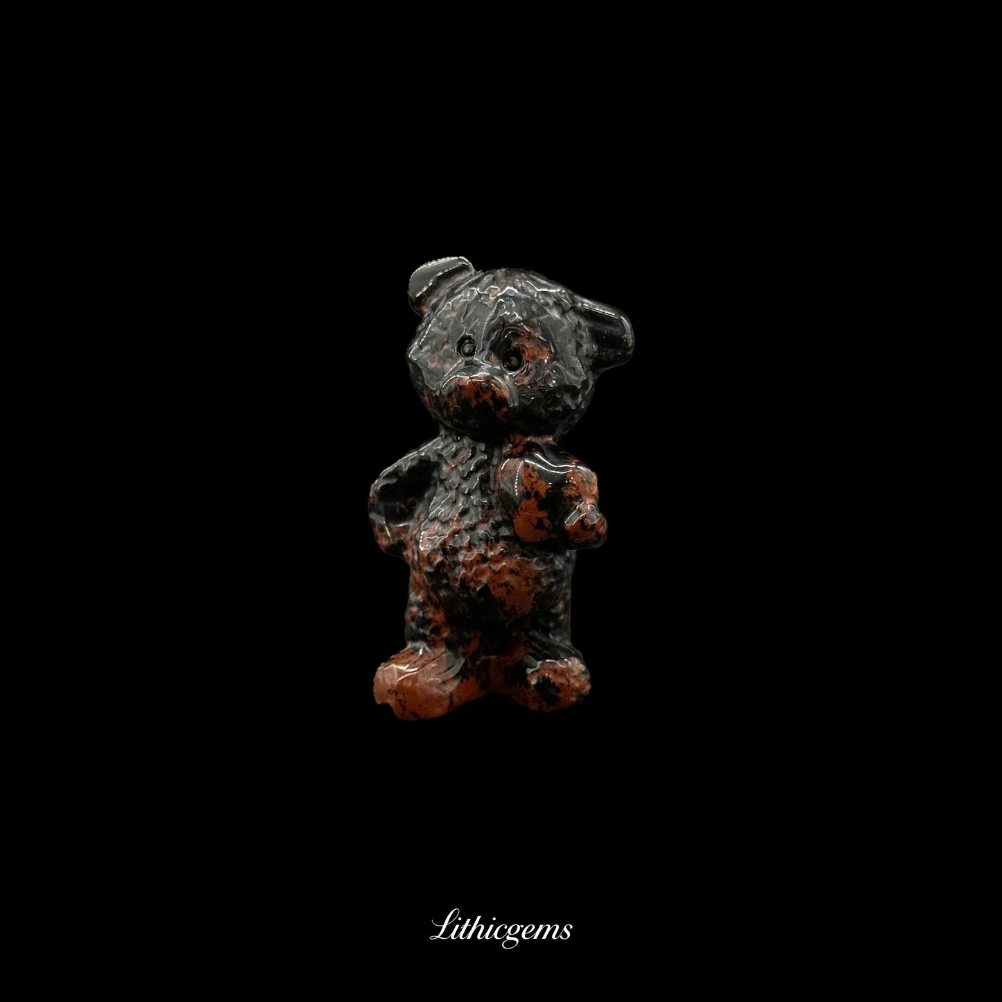 Red and black crystal teddy bear figurine from Lithicgems on black background