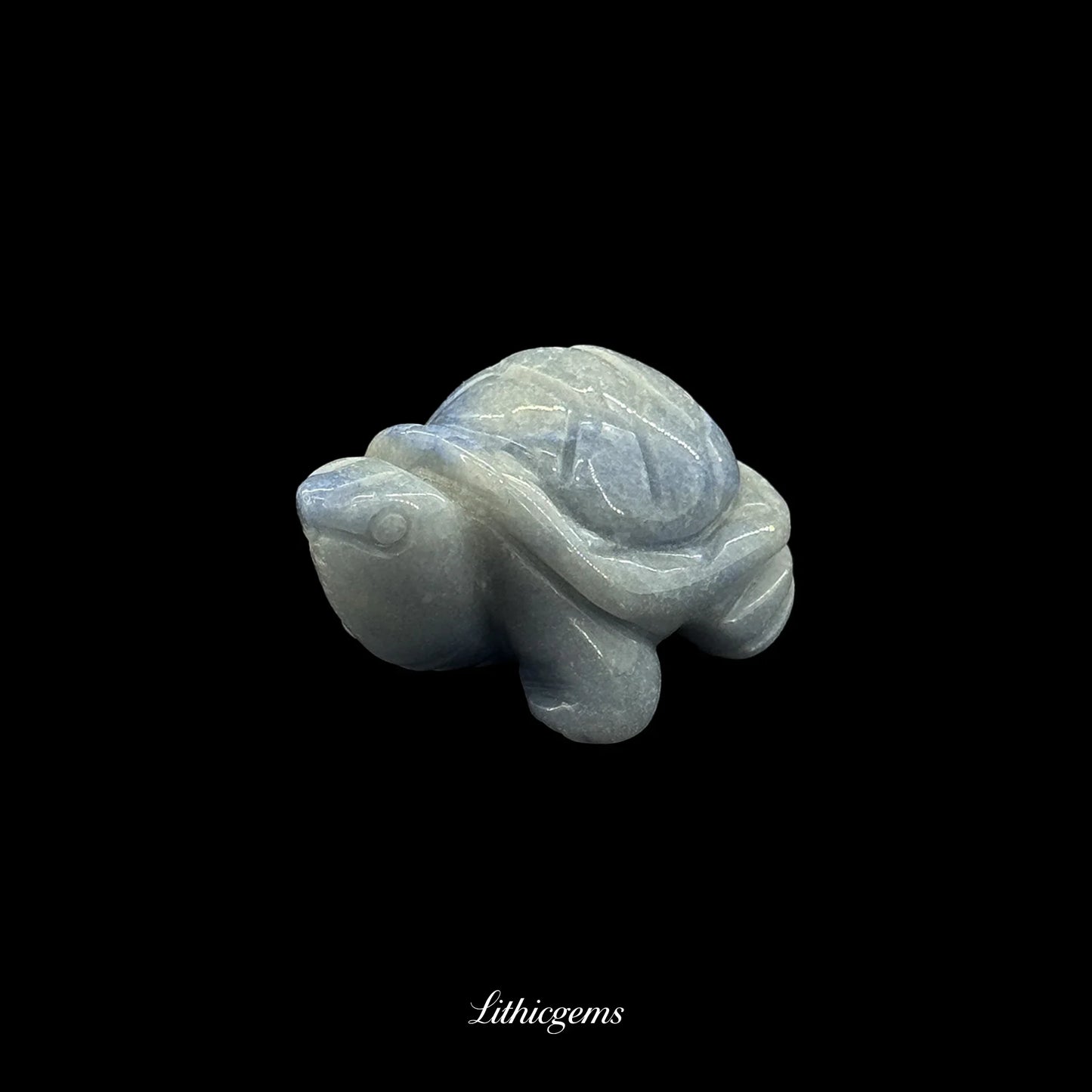 Natural crystal gemstone turtle figurine from Lithicgems on black background